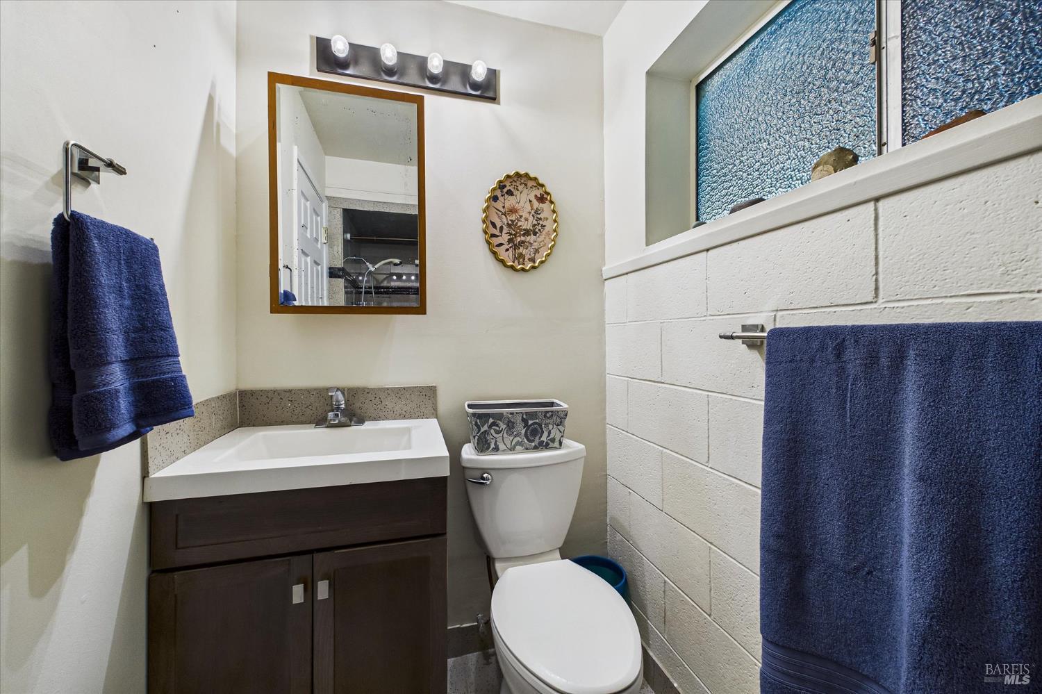 2305 Harris Street Eureka, CA 95503 - Photo 27 of 31 a bathroom with a toilet a sink and a mirror