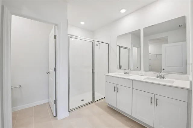 a bathroom with a double vanity sink and mirror