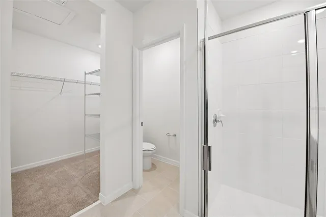 a bathroom with a granite countertop shower and a toilet