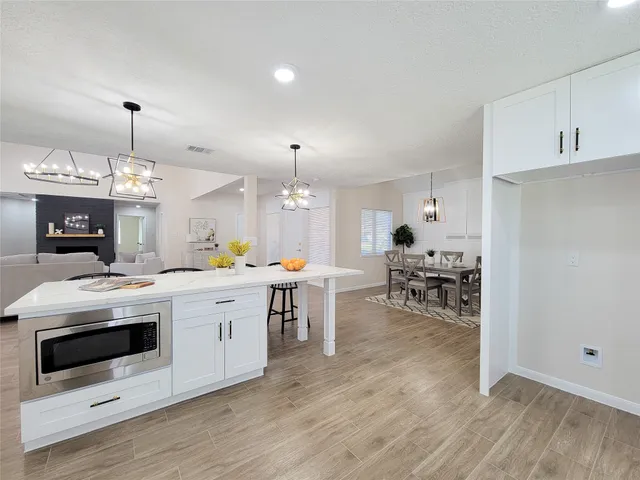 a kitchen with a stove cabinets and wooden floor