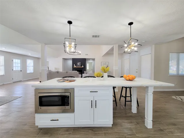 a kitchen that has a stove a table and chairs in it