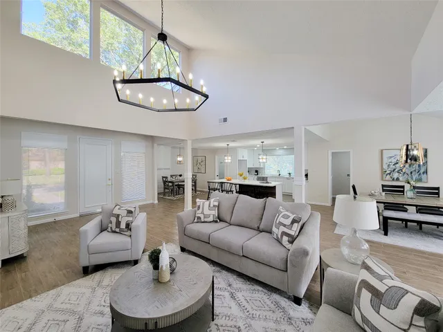a living room with furniture and a chandelier