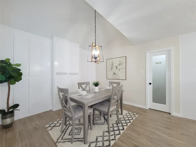 a view of a dining room with furniture and wooden floor