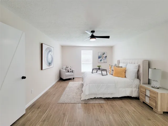 a bedroom with a bed and a night stand