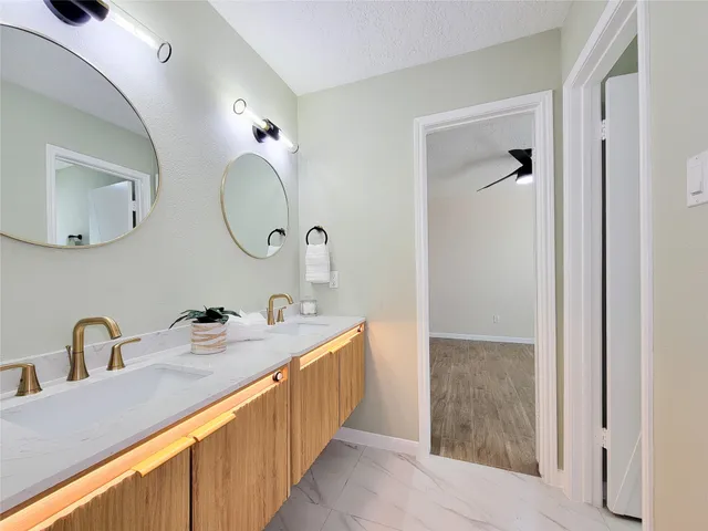 a bathroom with a double vanity sink and a mirror