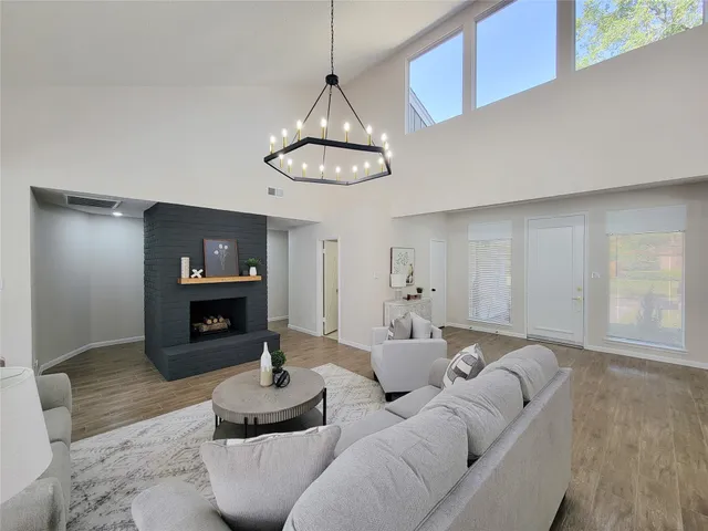 a living room with furniture a fireplace and a flat screen tv