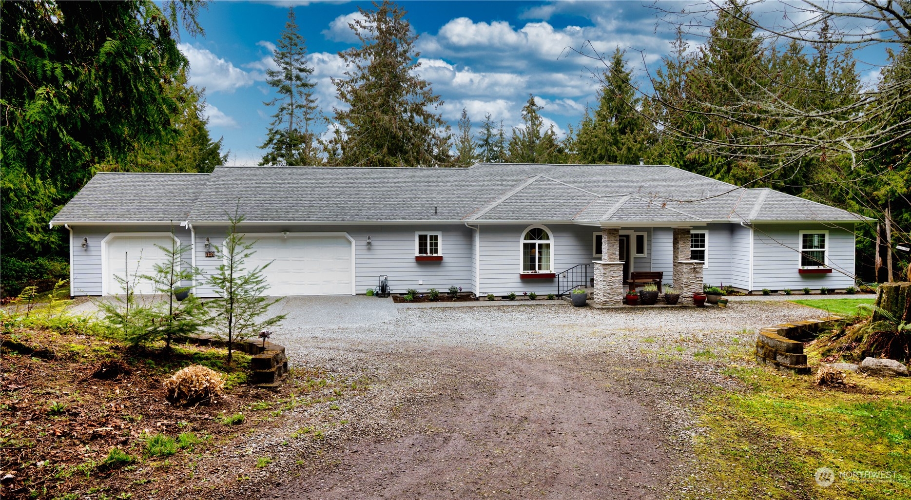 a front view of a house with a yard and outdoor seating