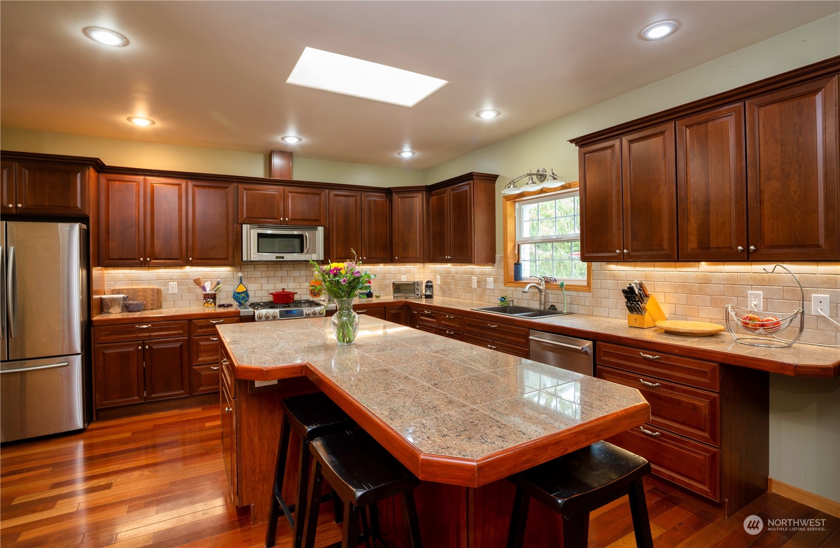 715 Palo Alto Road Sequim, WA 98382 - Photo 11 of 40 a kitchen with granite countertop wooden cabinets a counter top space a sink and stainless steel appliances