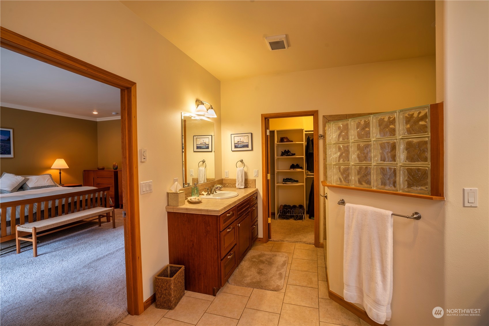 715 Palo Alto Road Sequim, WA 98382 - Photo 18 of 40 a en suite bathroom with a sink and a mirror