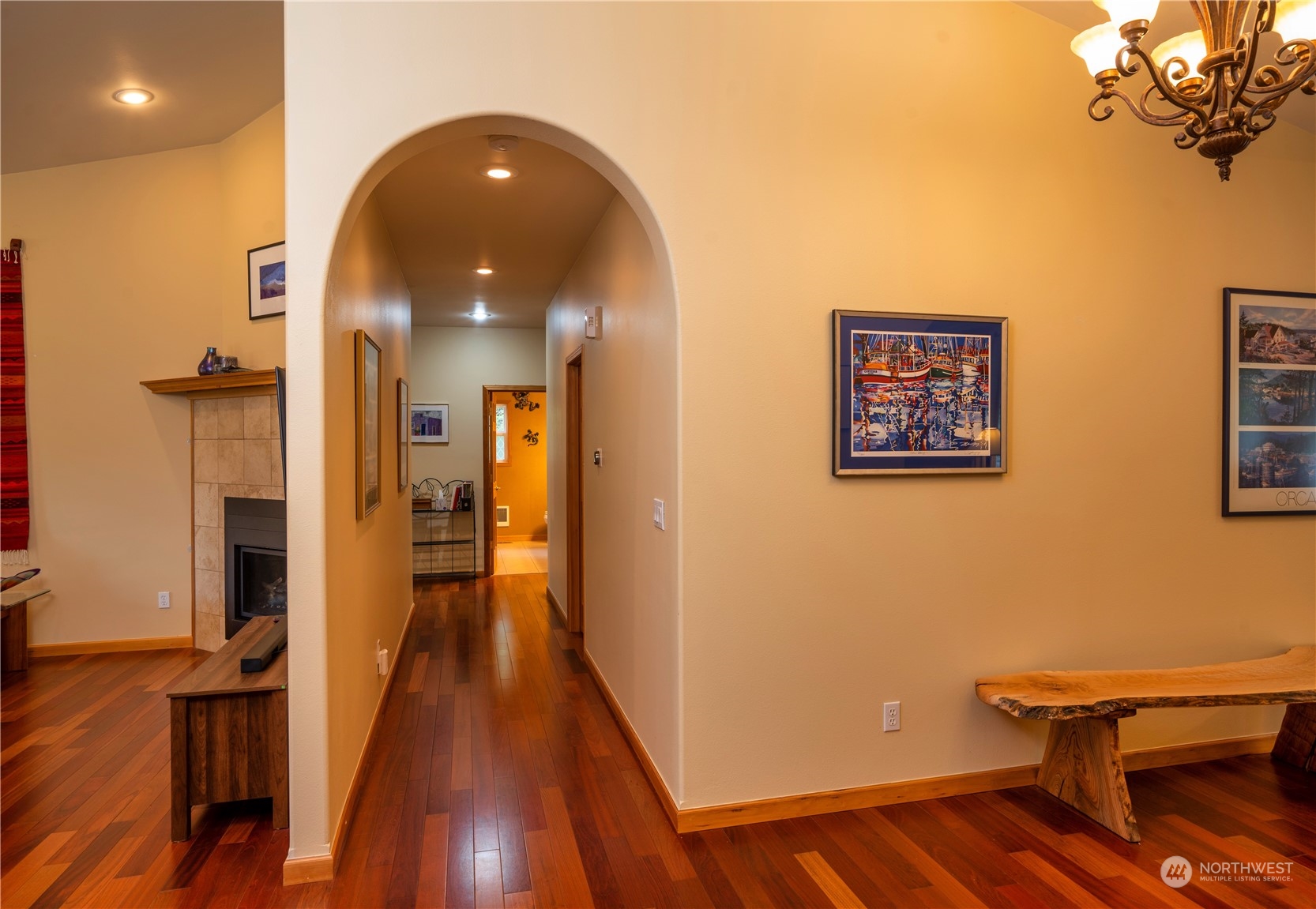 715 Palo Alto Road Sequim, WA 98382 - Photo 21 of 40 a view of a hallway with wooden floor and a living room