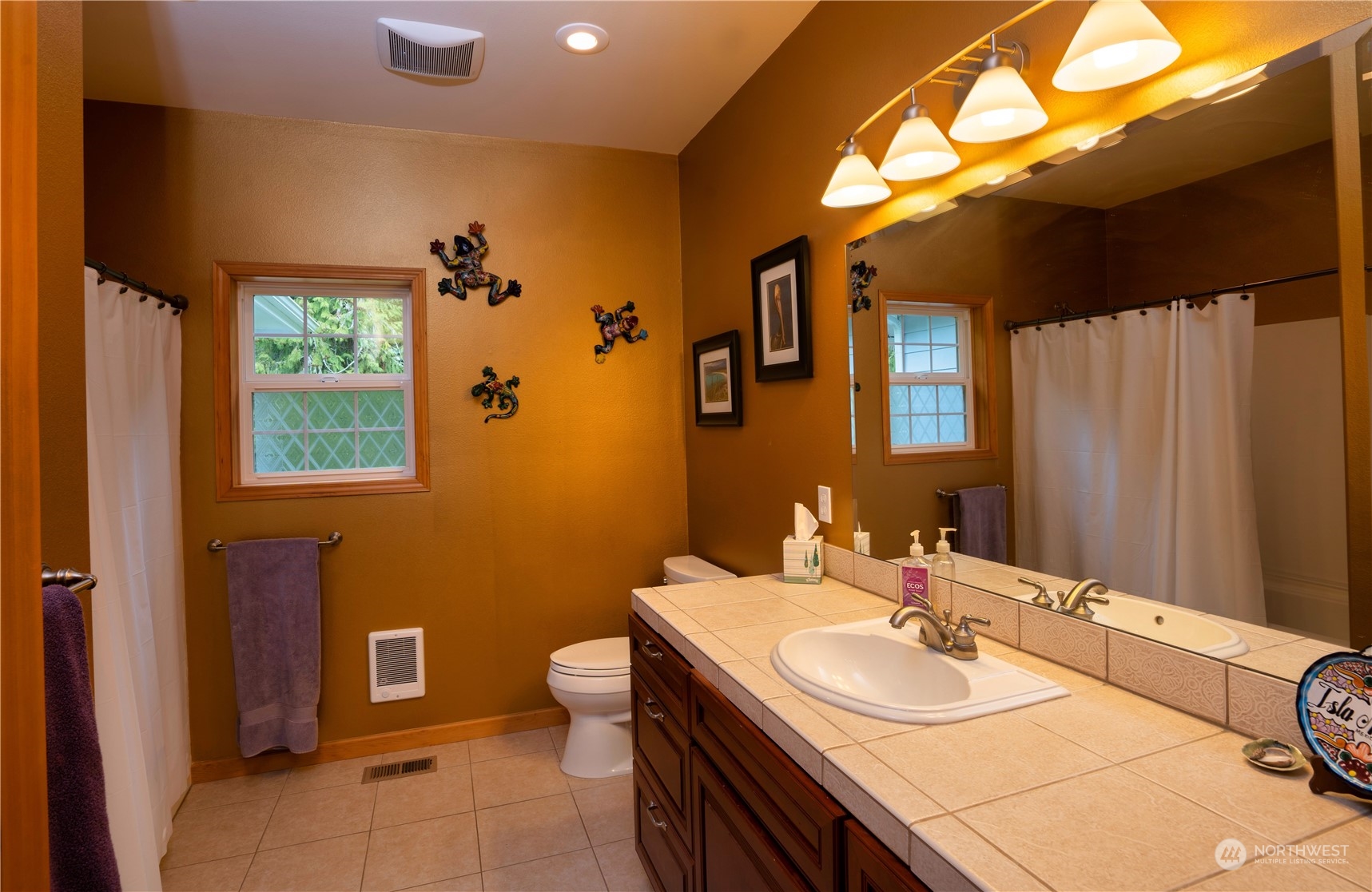 715 Palo Alto Road Sequim, WA 98382 - Photo 24 of 40 a bathroom with a sink and a mirror