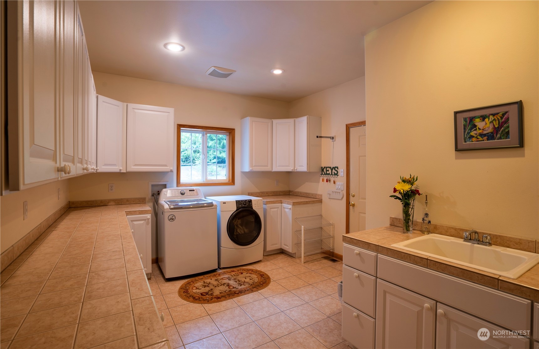 715 Palo Alto Road Sequim, WA 98382 - Photo 25 of 40 a kitchen with a sink a stove cabinets and a window