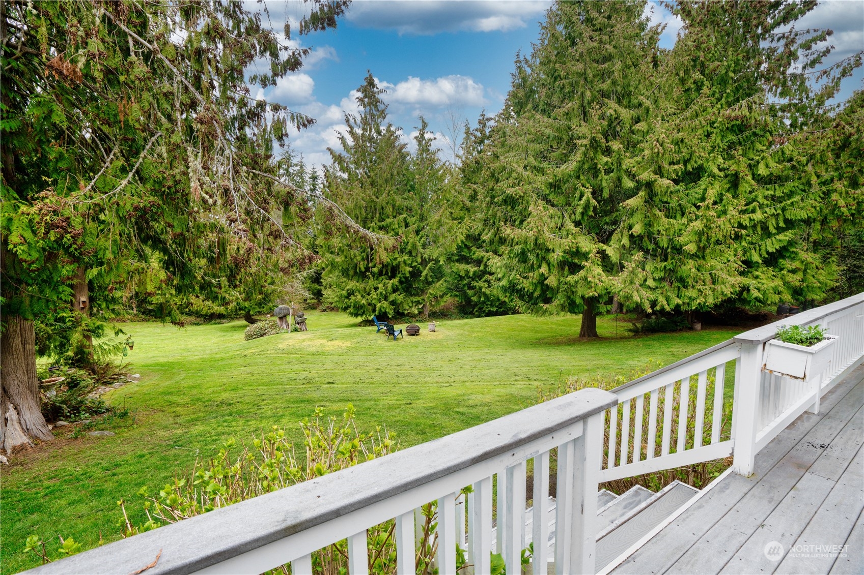 715 Palo Alto Road Sequim, WA 98382 - Photo 28 of 40 a view of a wooden deck and a yard