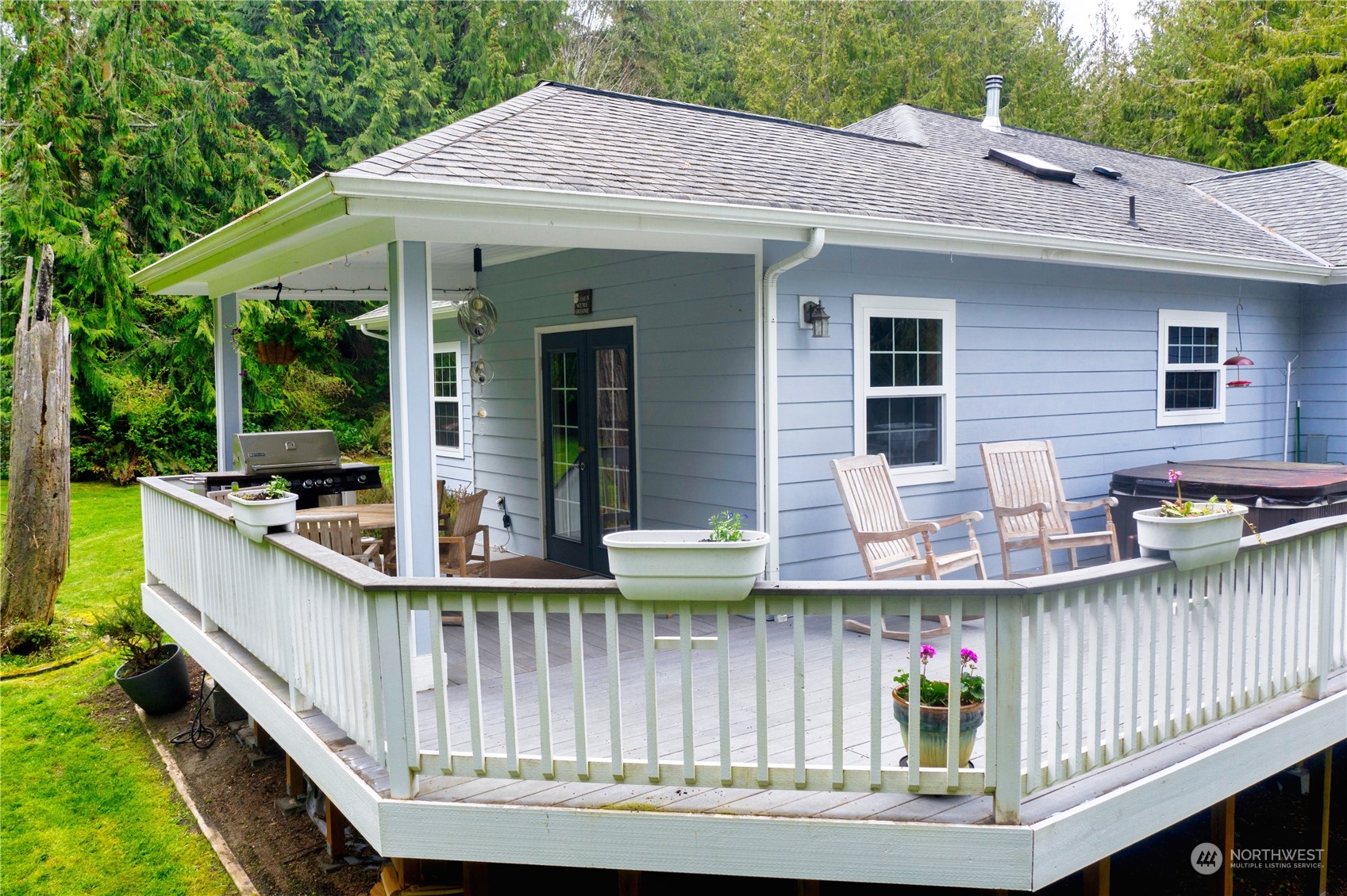 715 Palo Alto Road Sequim, WA 98382 - Photo 29 of 40 a view of a house with wooden deck and furniture