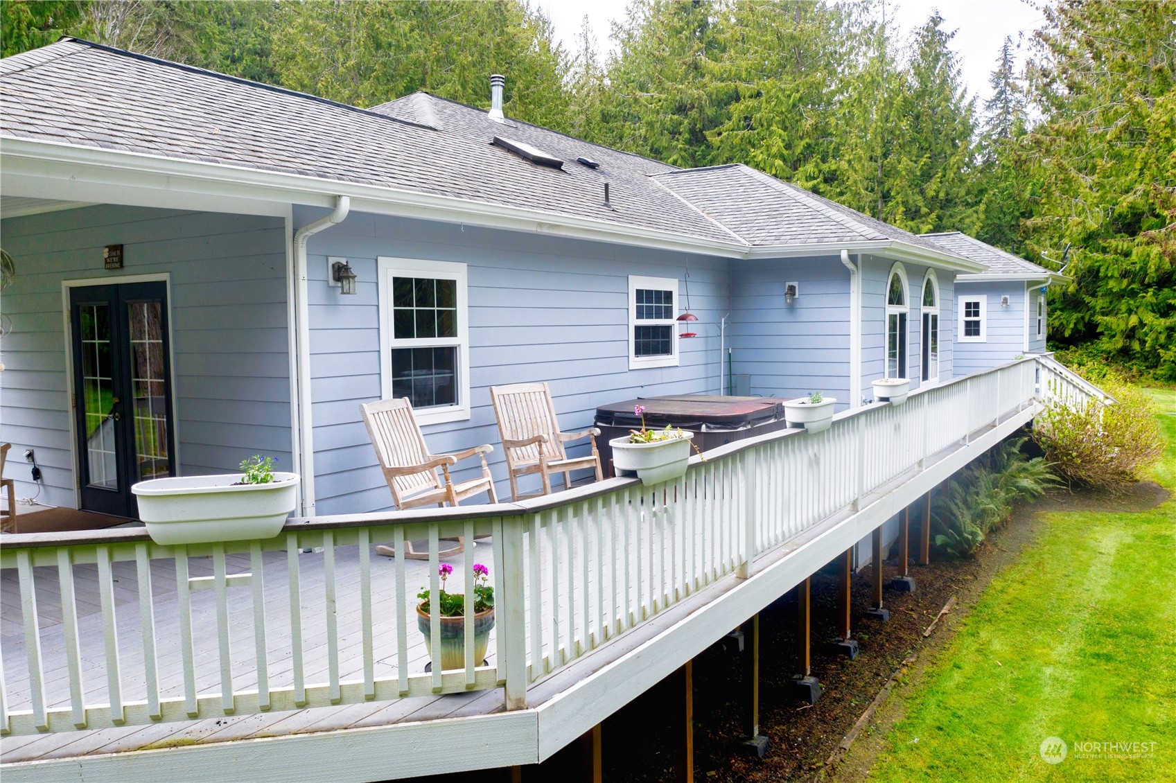 715 Palo Alto Road Sequim, WA 98382 - Photo 30 of 40 a view of a house with wooden deck and furniture
