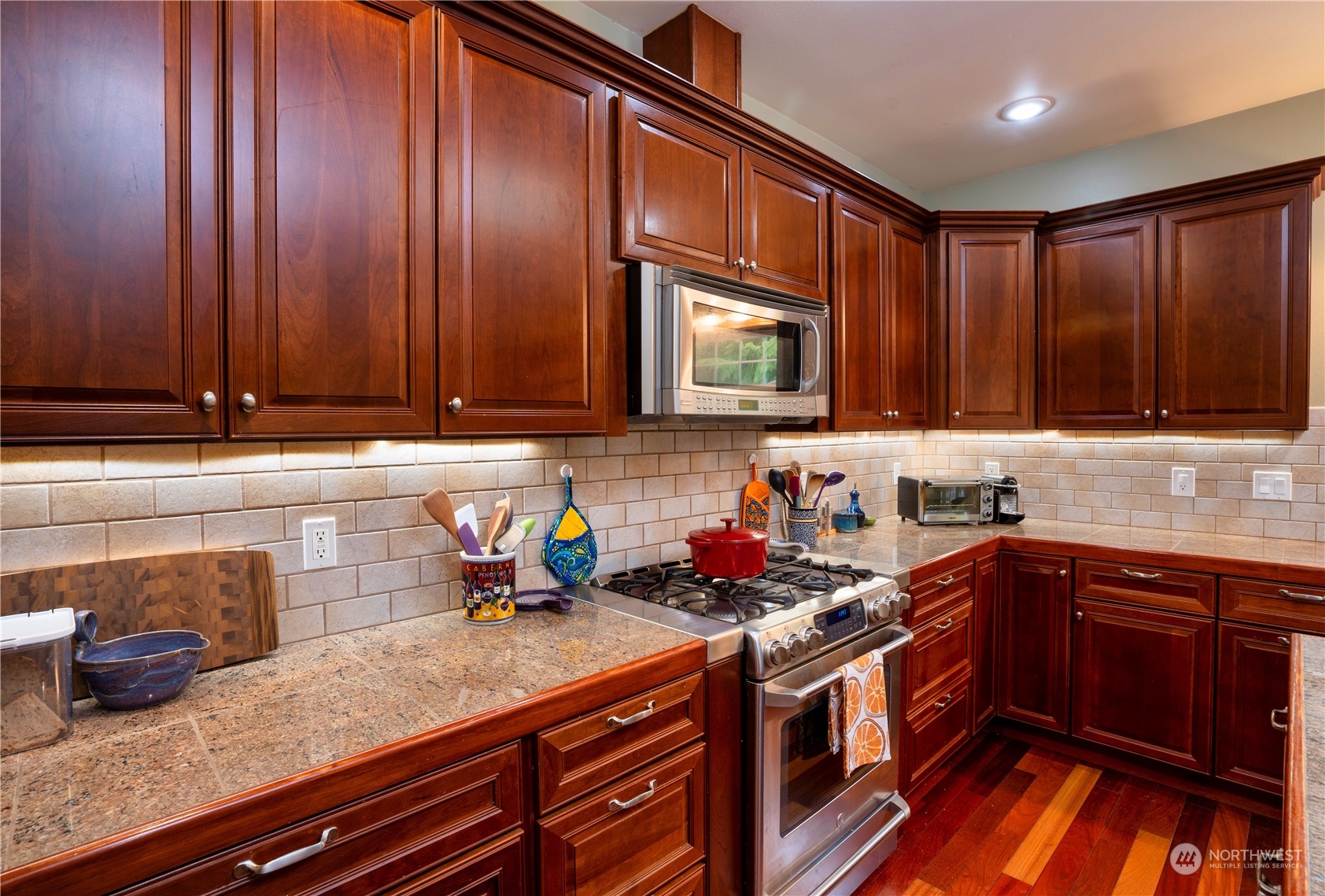 715 Palo Alto Road Sequim, WA 98382 - Photo 9 of 40 a kitchen with stainless steel appliances granite countertop wooden cabinets a sink and dishwasher