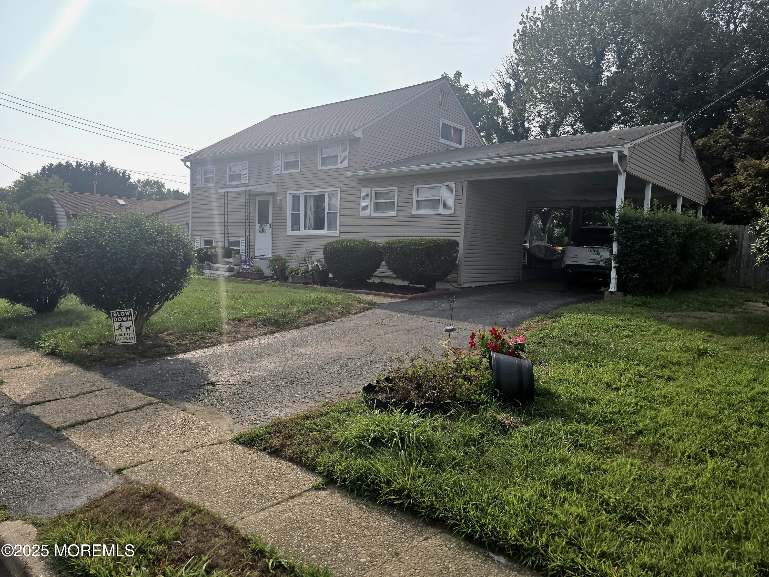 11 Trident Boulevard Neptune Township, NJ 07753 - Photo 23 of 25 a front view of a house with a garden and plants