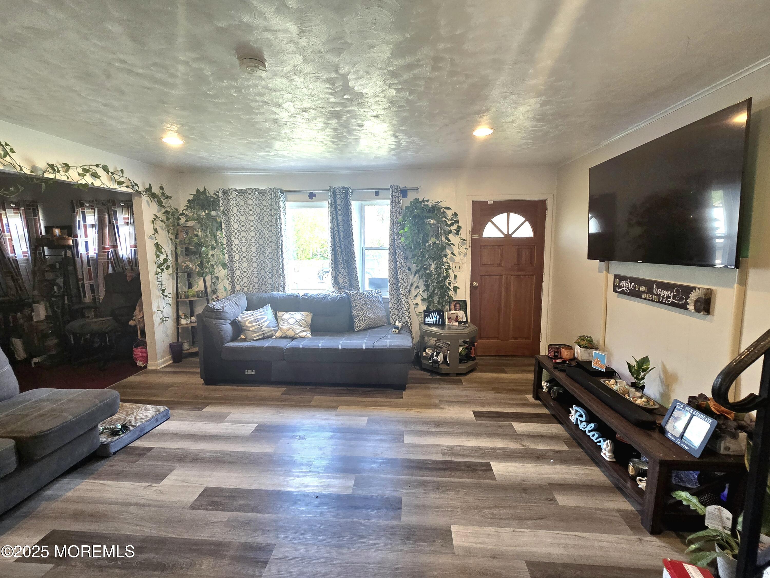11 Trident Boulevard Neptune Township, NJ 07753 - Photo 7 of 25 a living room with furniture and a flat screen tv