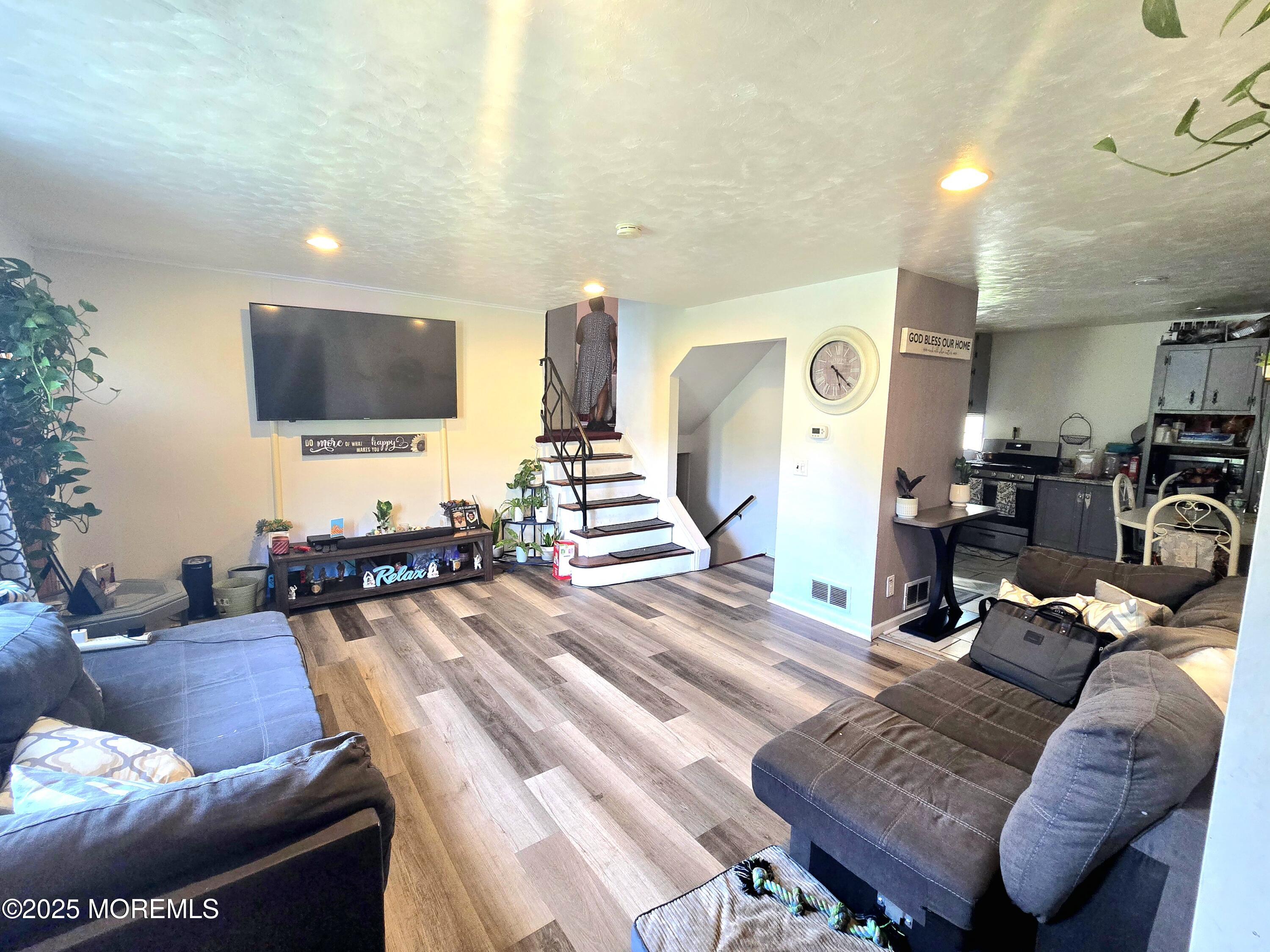 11 Trident Boulevard Neptune Township, NJ 07753 - Photo 8 of 25 a living room with furniture and a flat screen tv