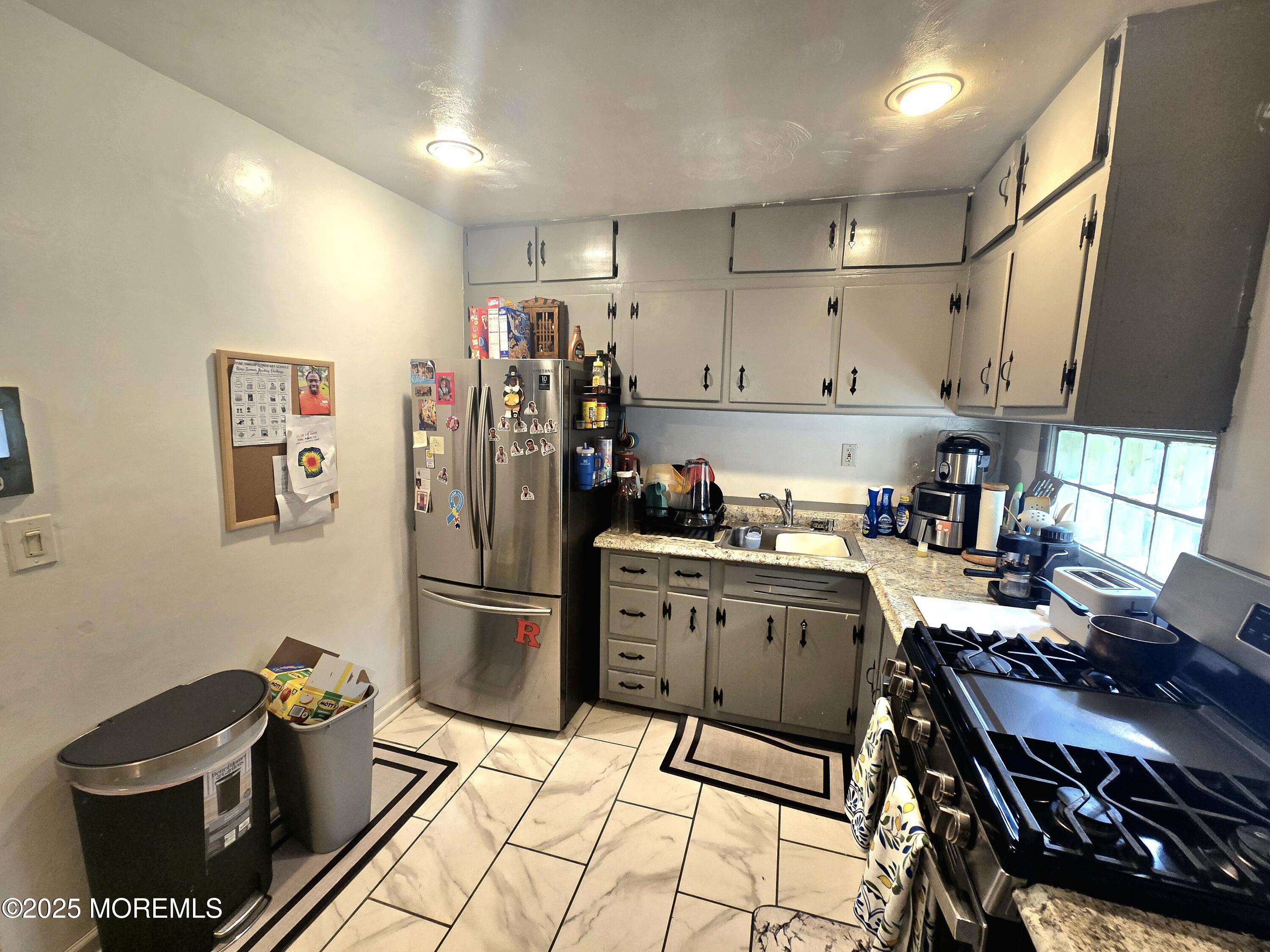 11 Trident Boulevard Neptune Township, NJ 07753 - Photo 10 of 25 a kitchen with a stove and a refrigerator