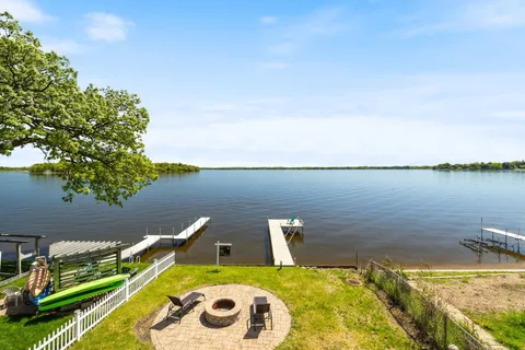 a view of a lake with couches chairs