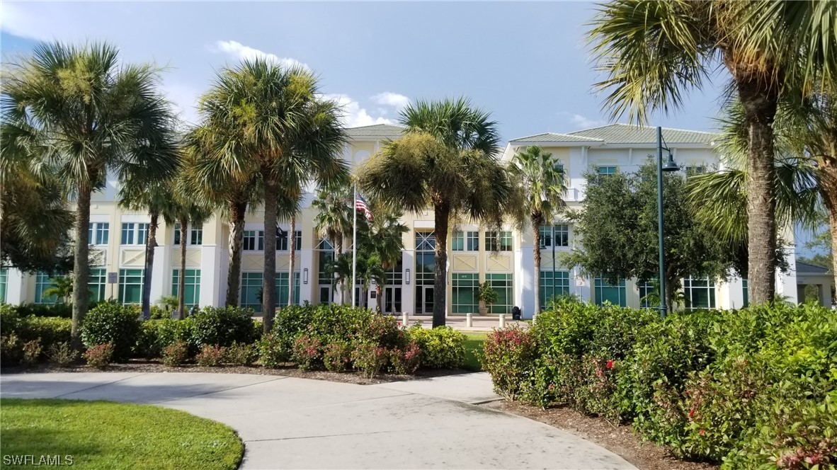 954126511 Trolley Rd Port North Port, FL 34291 - Photo 14 of 43 a front view of multi story residential apartment building with yard and green space