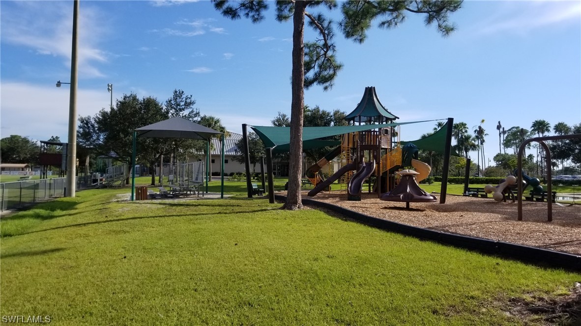 954126511 Trolley Rd Port North Port, FL 34291 - Photo 26 of 43 a view of a swimming pool with lawn chairs under an umbrella