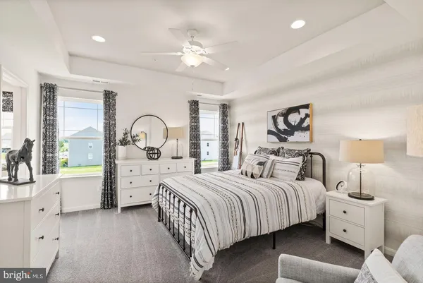 a bedroom with bed and a large window