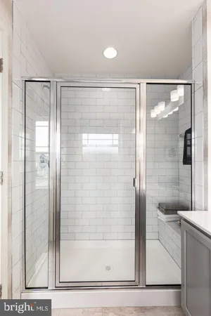 a bathroom with a glass shower door