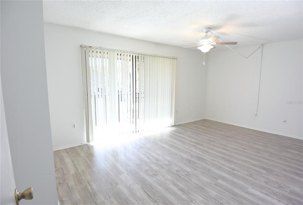 935 Sunridge Way, Unit B4 Sarasota, FL 34234 - Photo 17 of 45 wooden floor in an empty room with a window