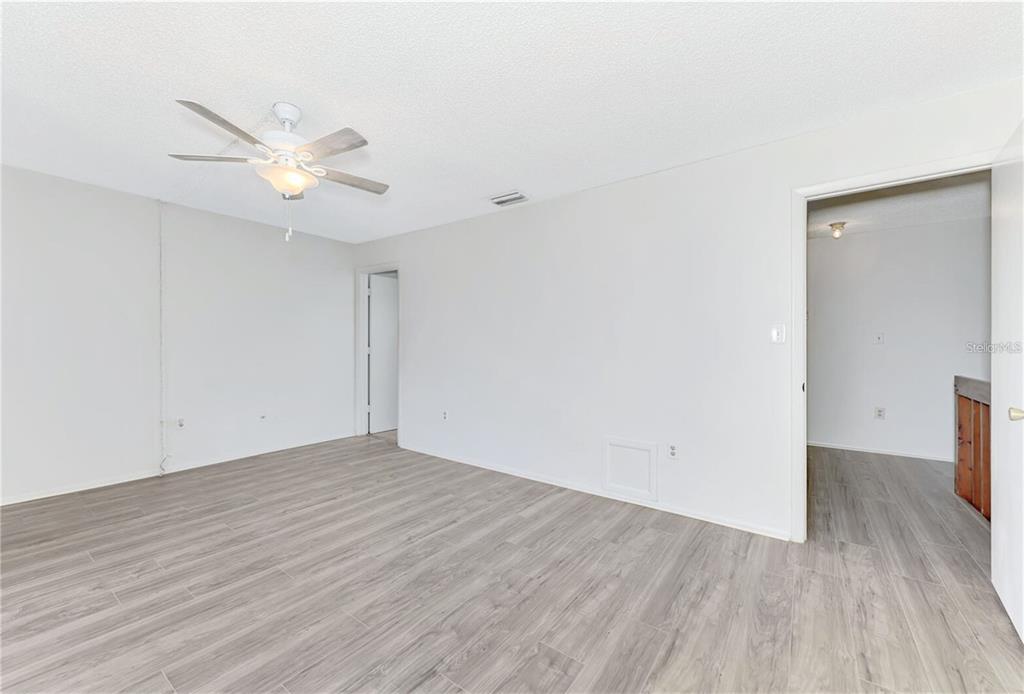 935 Sunridge Way, Unit B4 Sarasota, FL 34234 - Photo 19 of 45 a view of an empty room with wooden floor