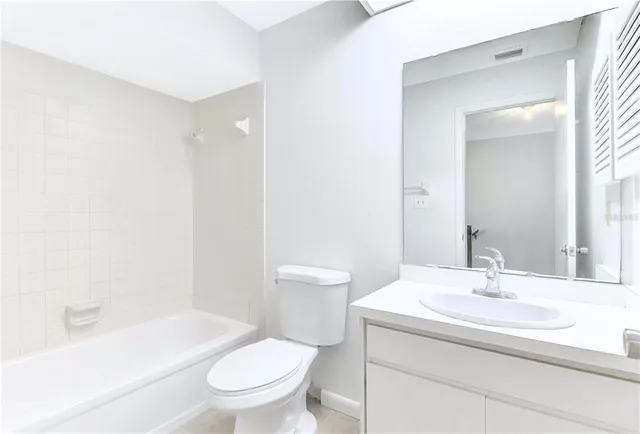 a bathroom with a sink toilet and a mirror