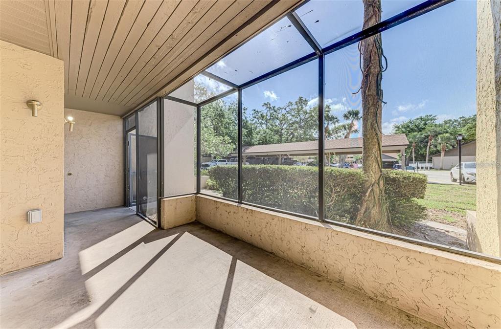 935 Sunridge Way, Unit B4 Sarasota, FL 34234 - Photo 36 of 45 a view of an empty room with wooden floor and a window