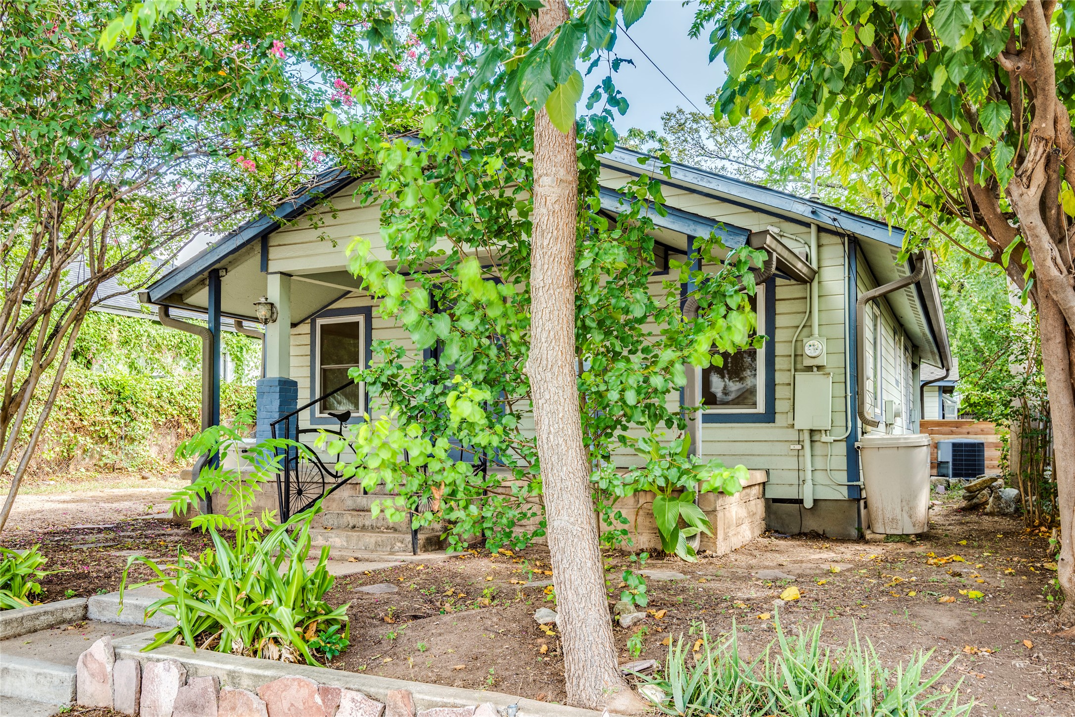 2314 Santa Rosa Street Austin, TX 78702 - Photo 24 of 29 A charming bungalow with a welcoming porch and mature landscaping offers serene living.