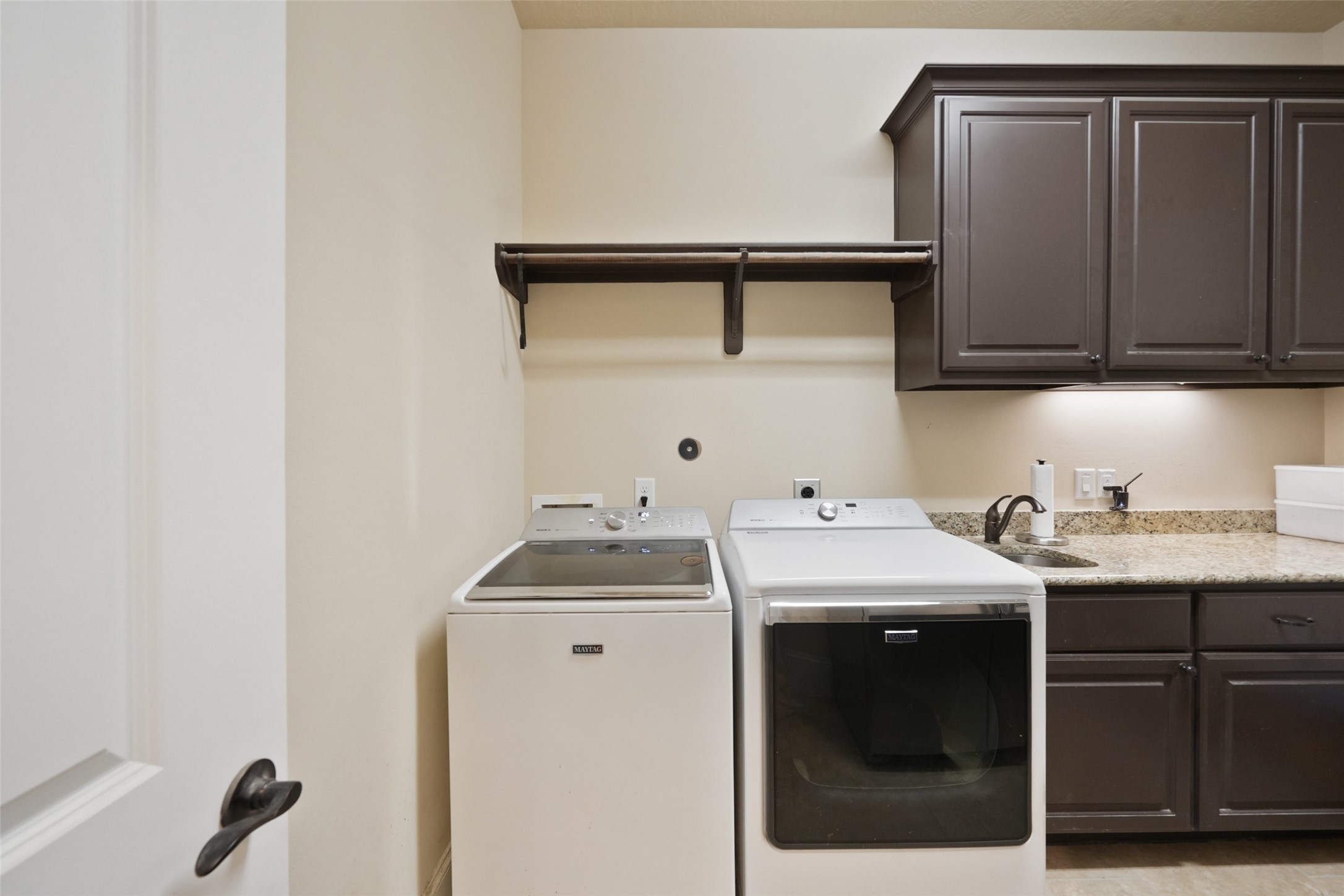26250 A Riley Road Waller, TX 77484 - Photo 23 of 50 Laundry room with granite counters, upper cabinetry, and utility sink—high-capacity setup for everyday use and guest turnover.