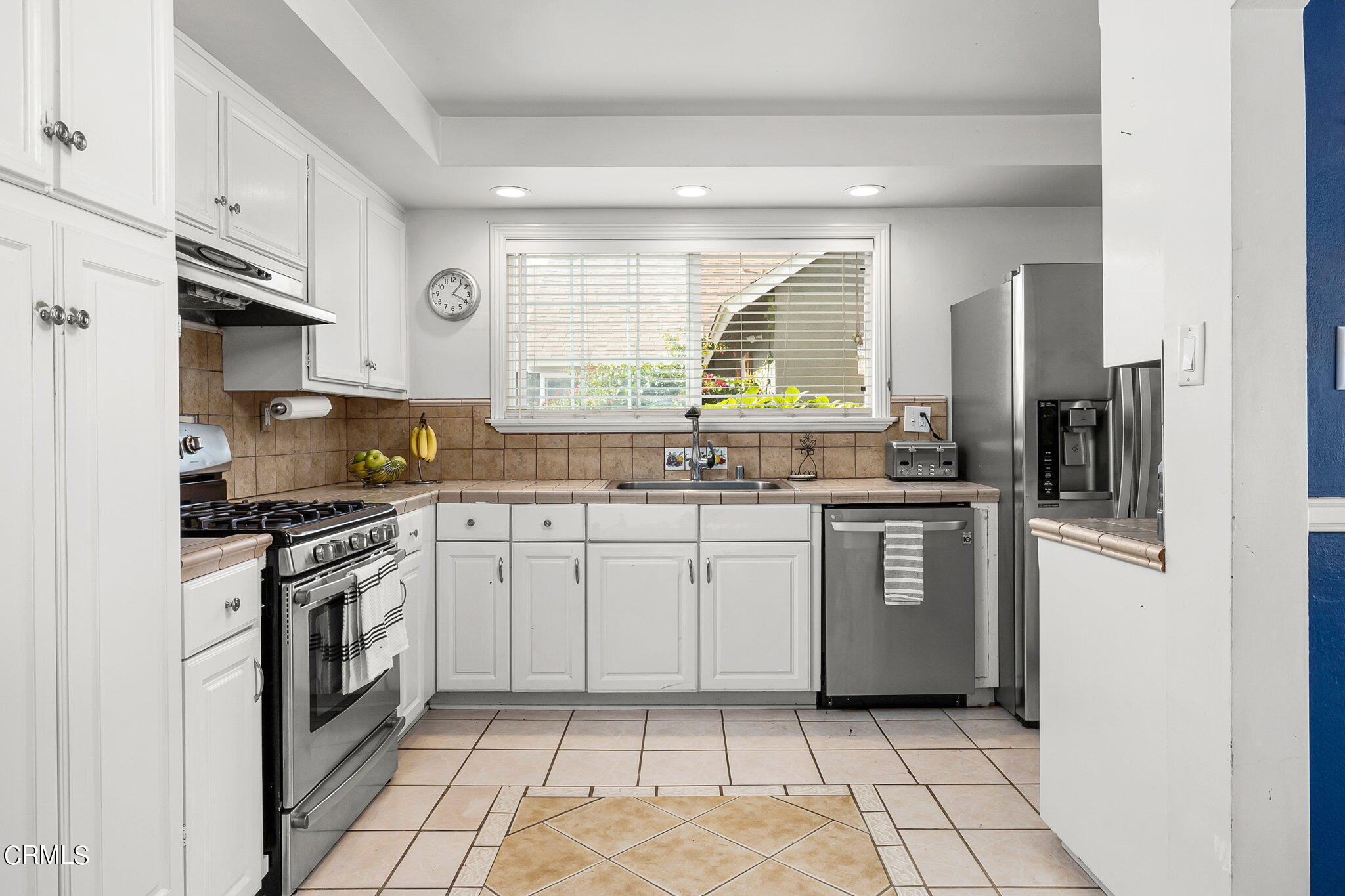 1201 West Roderick Avenue Oxnard, CA 93030 - Photo 13 of 32 a kitchen with a sink a stove and cabinets