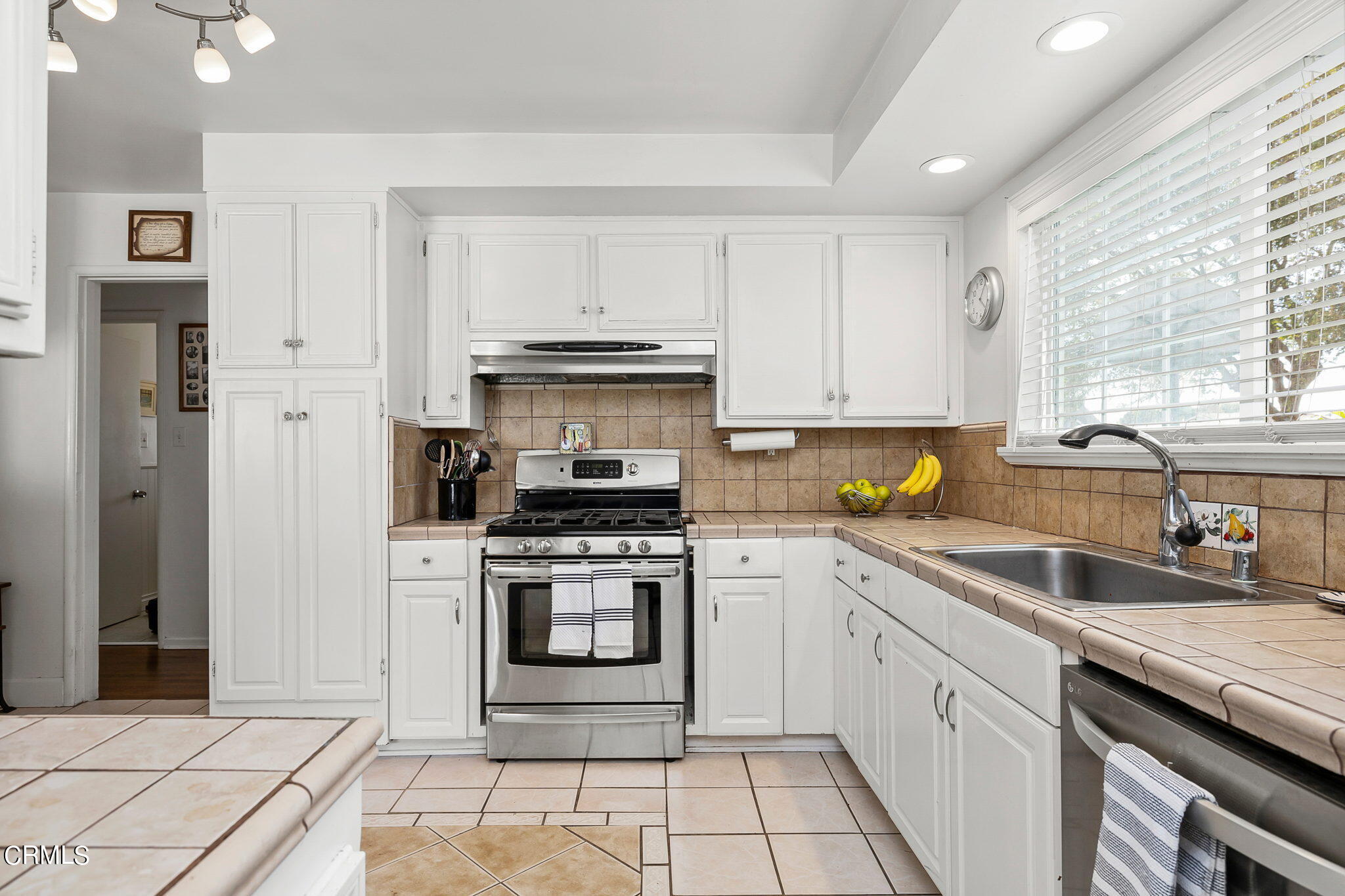 1201 West Roderick Avenue Oxnard, CA 93030 - Photo 14 of 32 a kitchen with a stove sink and cabinets