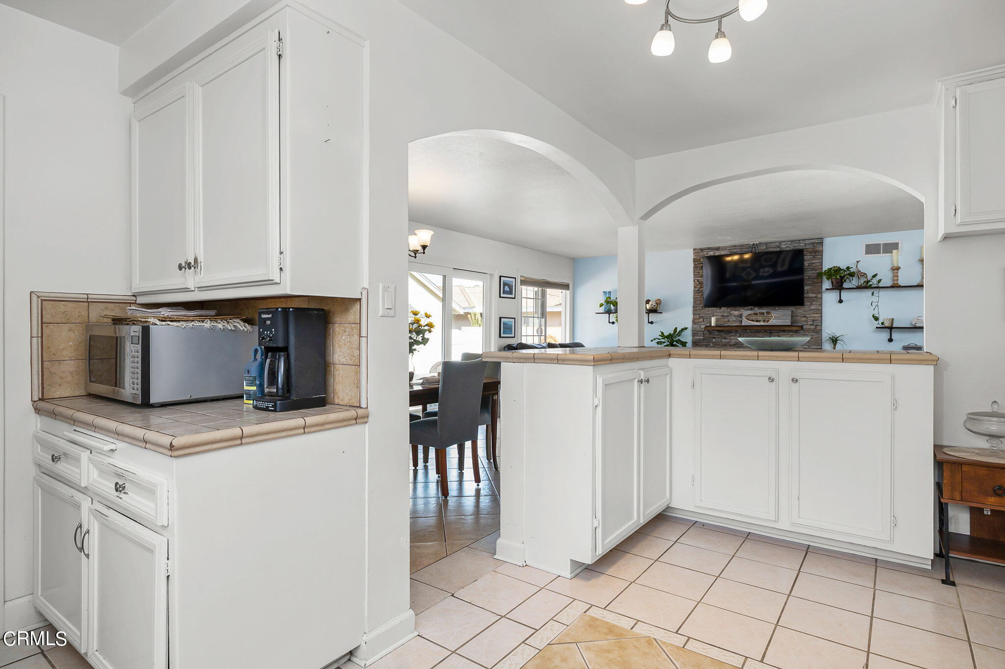 1201 West Roderick Avenue Oxnard, CA 93030 - Photo 15 of 32 a kitchen with white cabinets and appliances