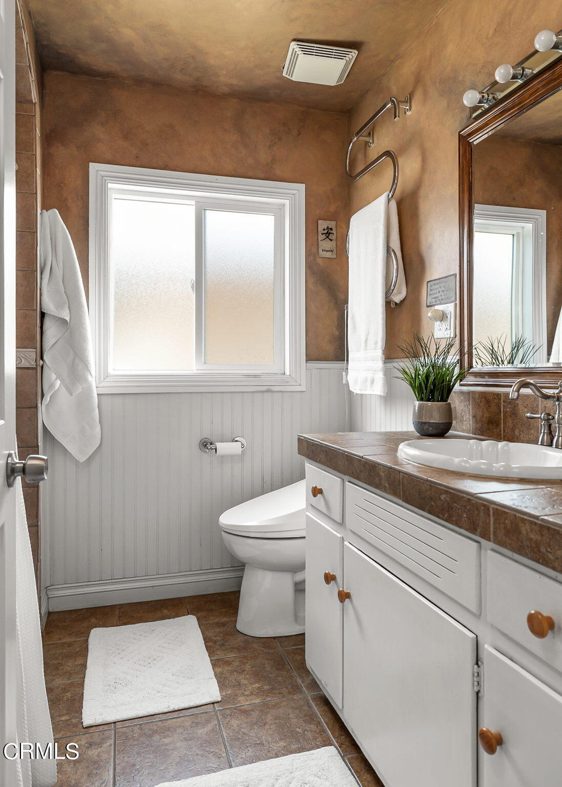 1201 West Roderick Avenue Oxnard, CA 93030 - Photo 18 of 32 a bathroom with a toilet a sink and a mirror
