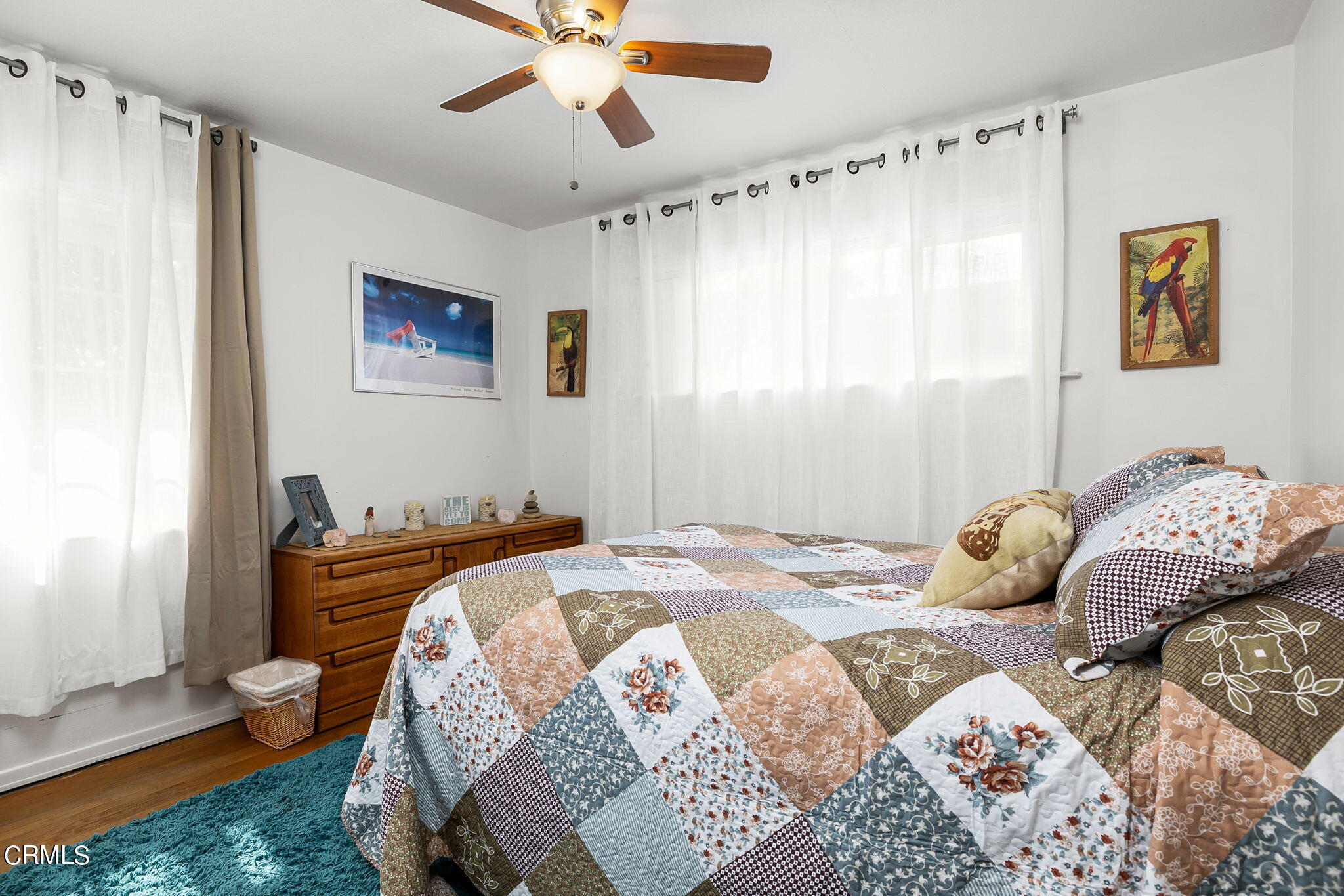 1201 West Roderick Avenue Oxnard, CA 93030 - Photo 23 of 32 a bedroom with a bed and a chandelier