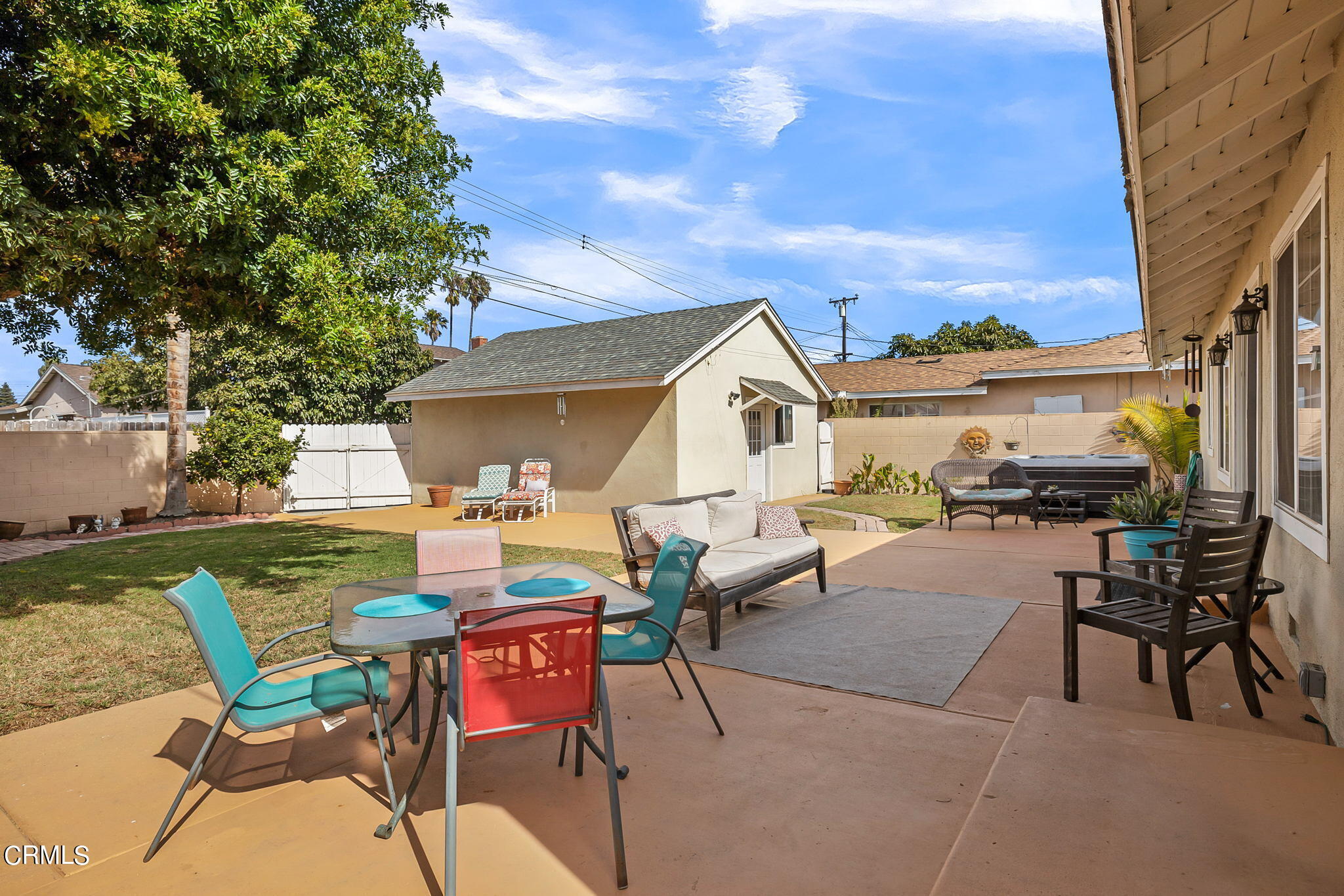 1201 West Roderick Avenue Oxnard, CA 93030 - Photo 26 of 32 a view of a patio with table and chairs and floor to ceiling window
