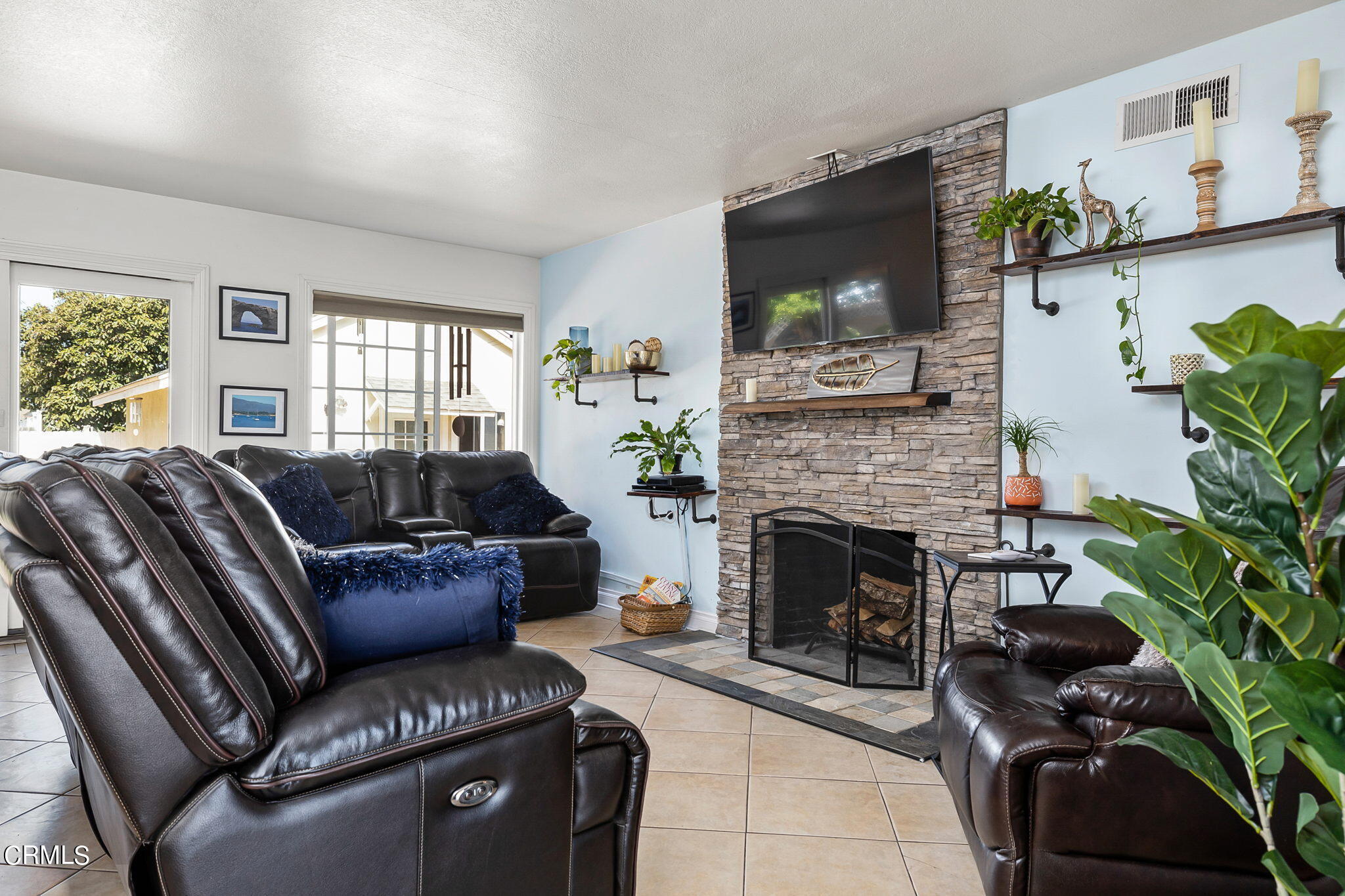 1201 West Roderick Avenue Oxnard, CA 93030 - Photo 7 of 32 a living room with furniture a flat screen tv and a fireplace