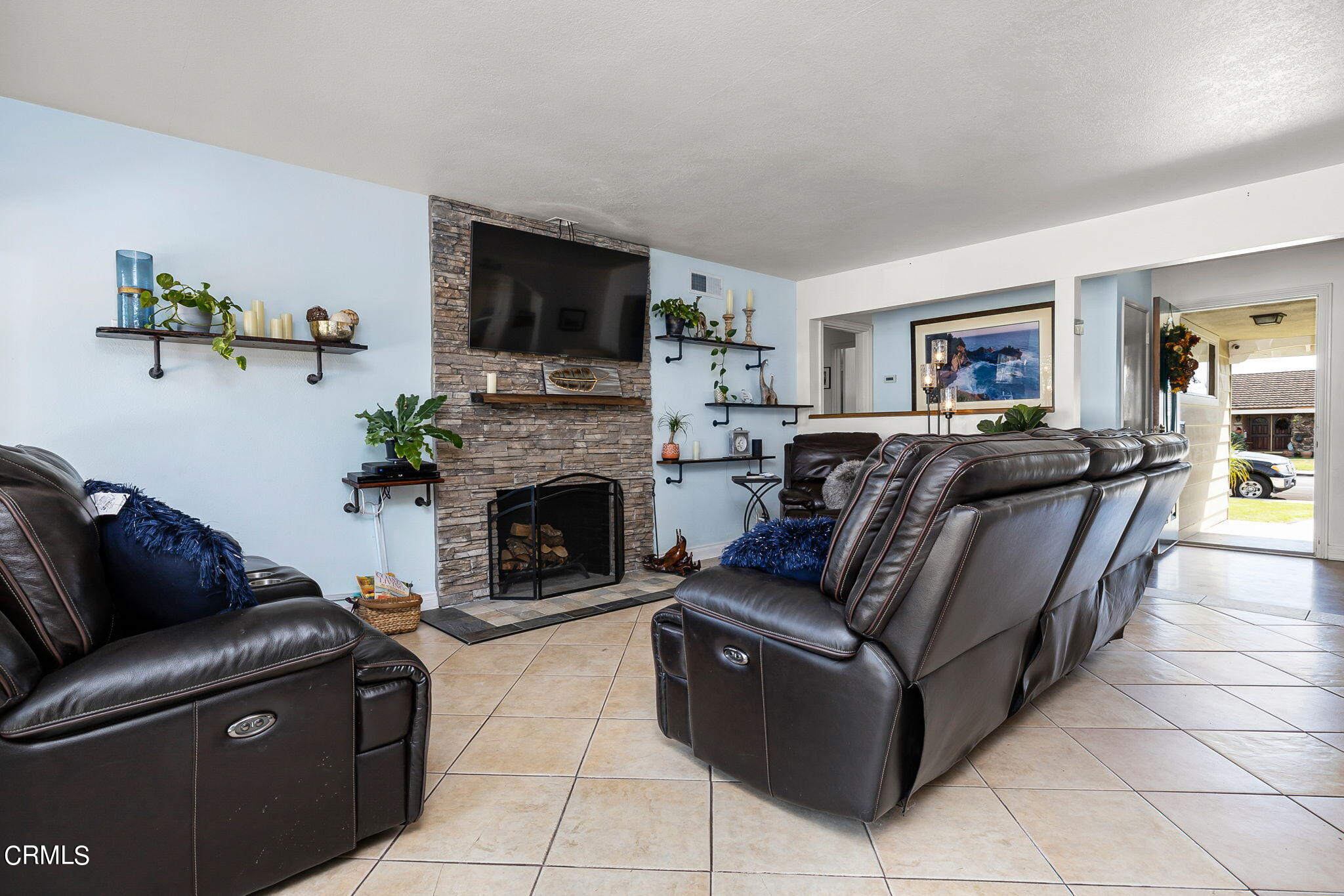 1201 West Roderick Avenue Oxnard, CA 93030 - Photo 8 of 32 a living room with furniture a flat screen tv and a fireplace