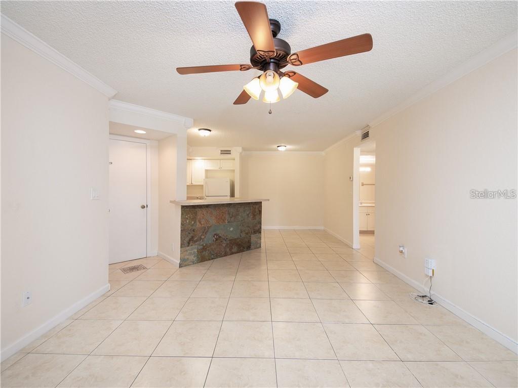 4606 Commander Drive, Unit 1124 Orlando, FL 32822 - Photo 4 of 16 a view of an empty room and kitchen view