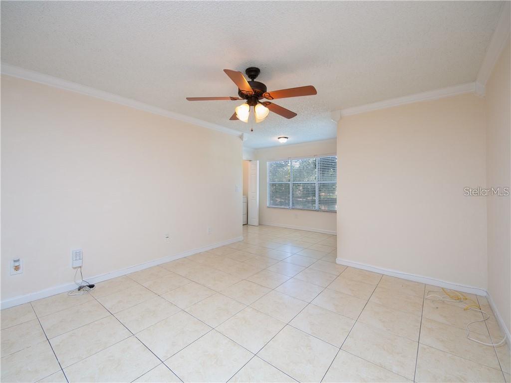 4606 Commander Drive, Unit 1124 Orlando, FL 32822 - Photo 6 of 16 wooden floor in an empty room with a window