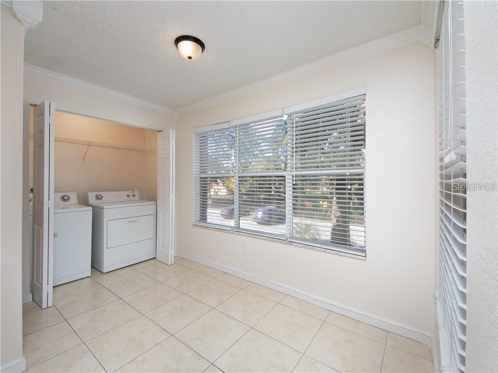 4606 Commander Drive, Unit 1124 Orlando, FL 32822 - Photo 7 of 16 a view of a kitchen with a sink dishwasher and a window