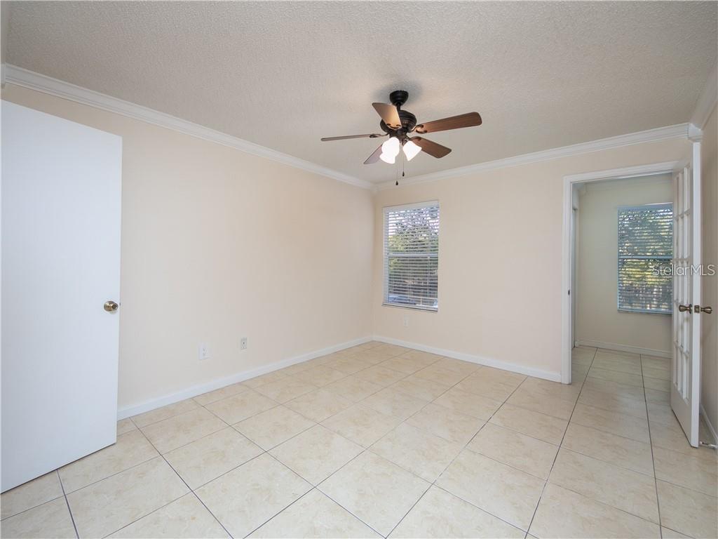 4606 Commander Drive, Unit 1124 Orlando, FL 32822 - Photo 9 of 16 a view of room with a ceiling fan and window