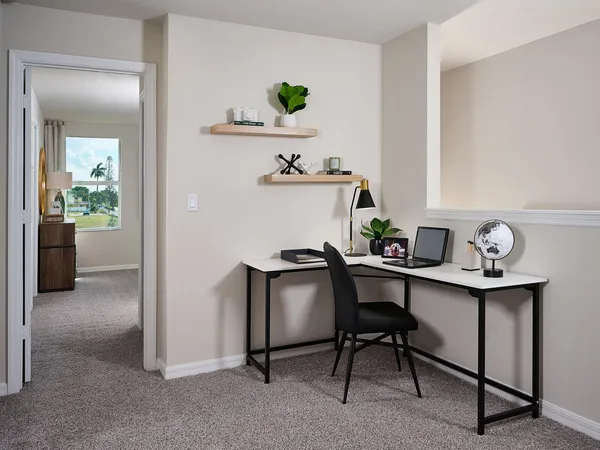 a view of a workspace with furniture