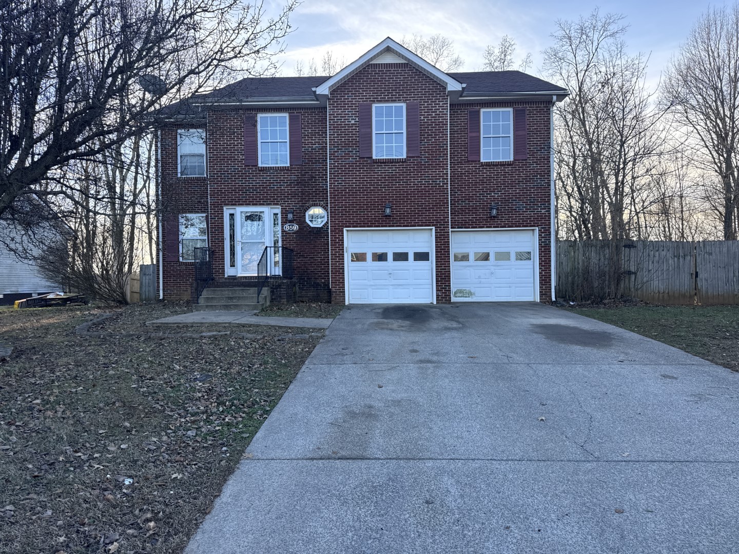 859 Sugarcane Way Clarksville, TN 37040 - Photo 1 of 13 a view of a brick house with a yard and large tree
