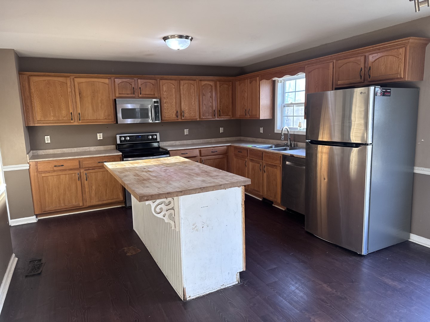 859 Sugarcane Way Clarksville, TN 37040 - Photo 2 of 13 a kitchen with stainless steel appliances granite countertop a refrigerator a oven a sink dishwasher and white cabinets with wooden floor